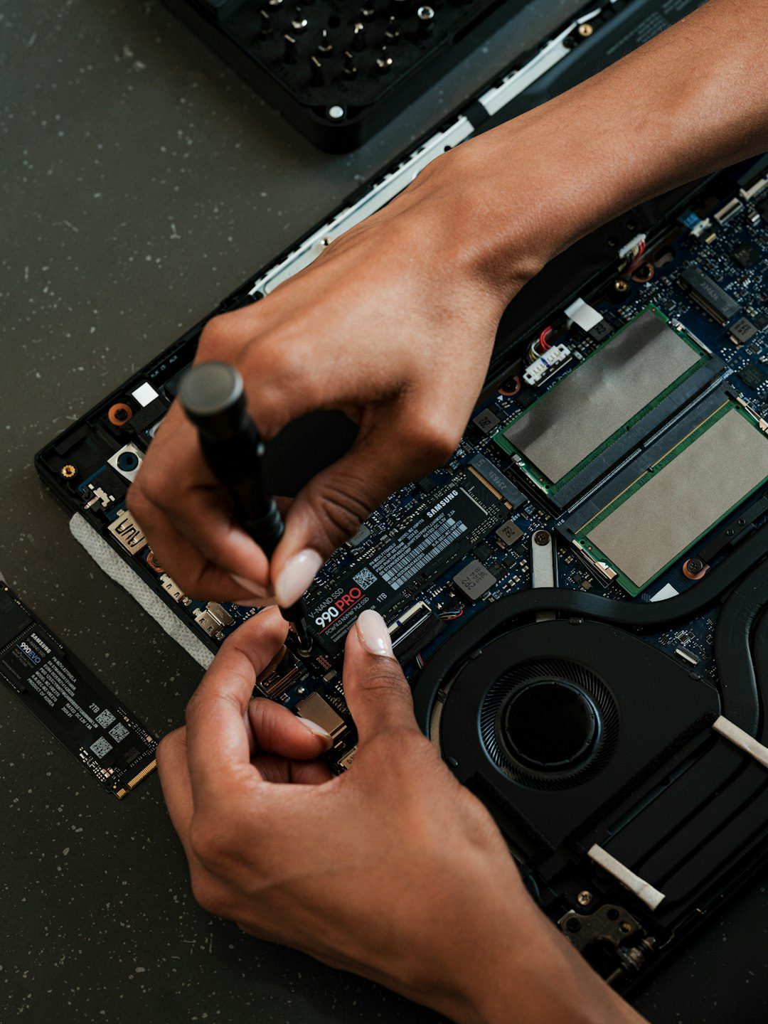 a-person-working-on-a-laptop-with-a-screwdriver-wr0qur6qcua